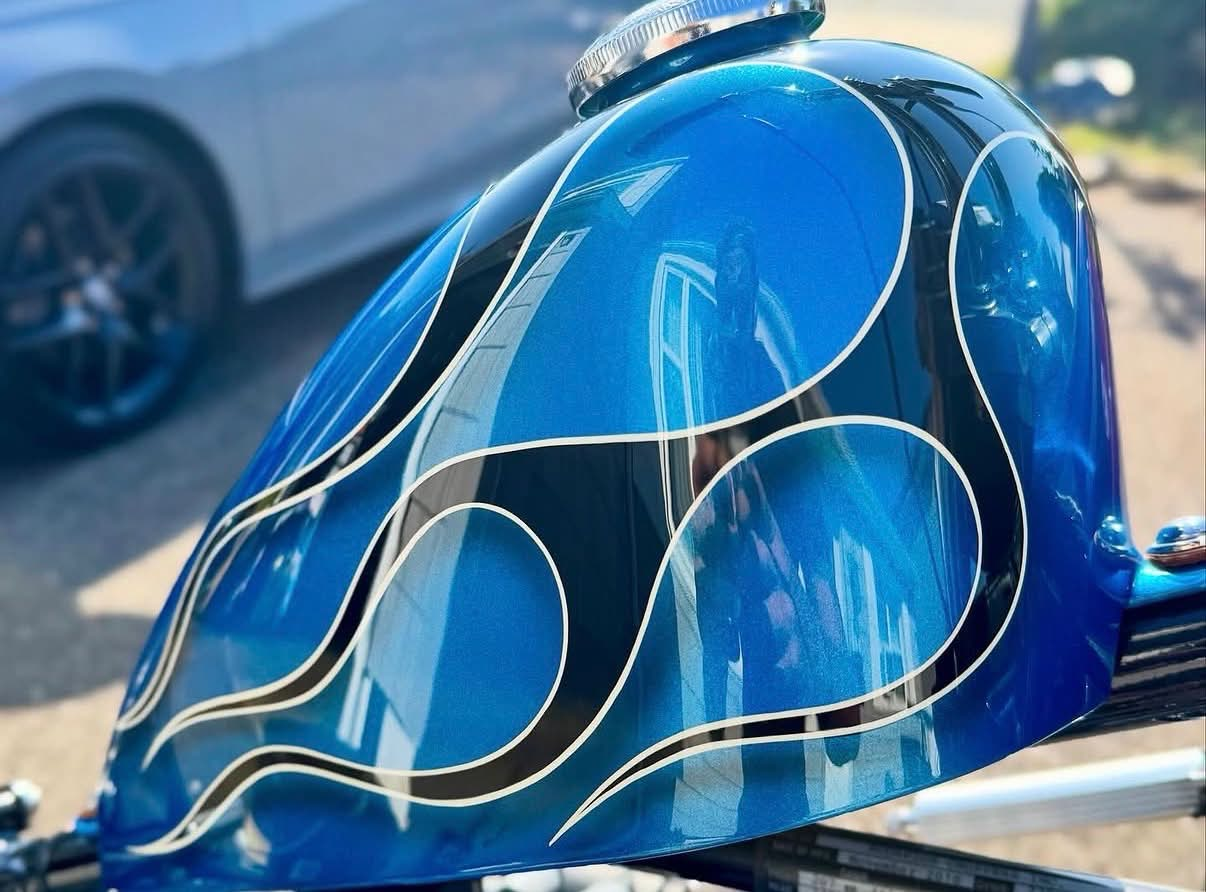 Blue custom motorcycle tank with polished paintwork