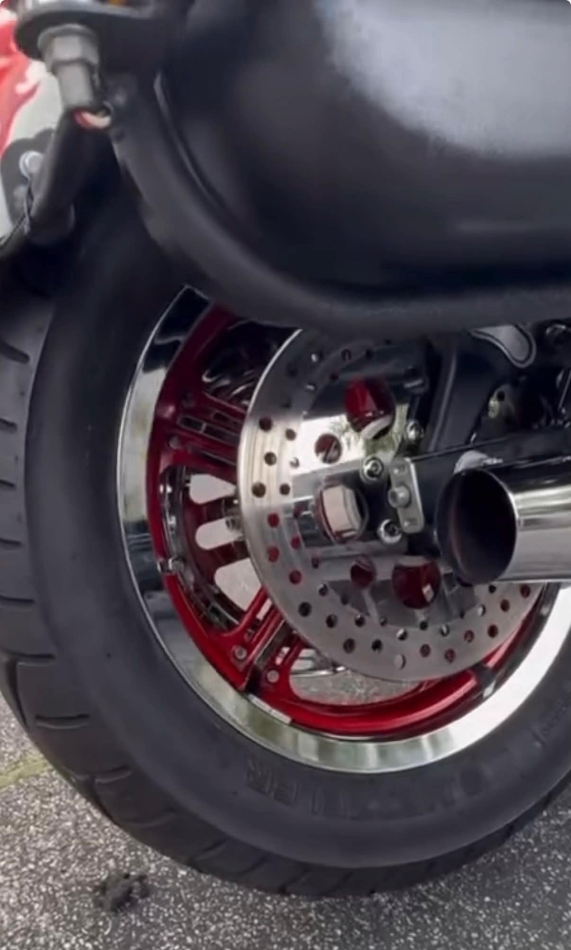 Detailed motorcycle rear wheel and chrome exhaust close-up
